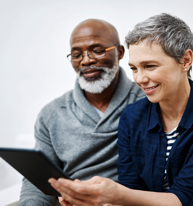 A woman and man using PocketHealth on a tablet
