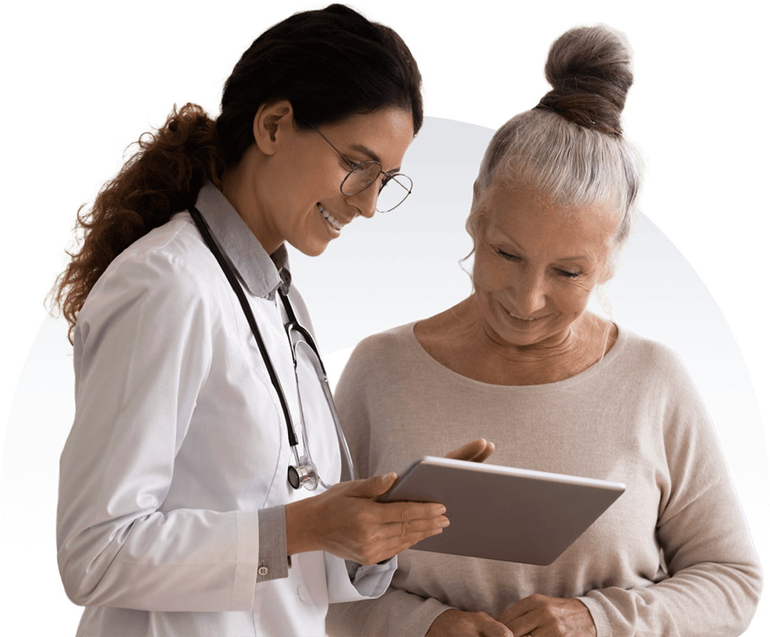 A doctor and patient examine information displayed on a tablet, discussing details with engaged expressions.