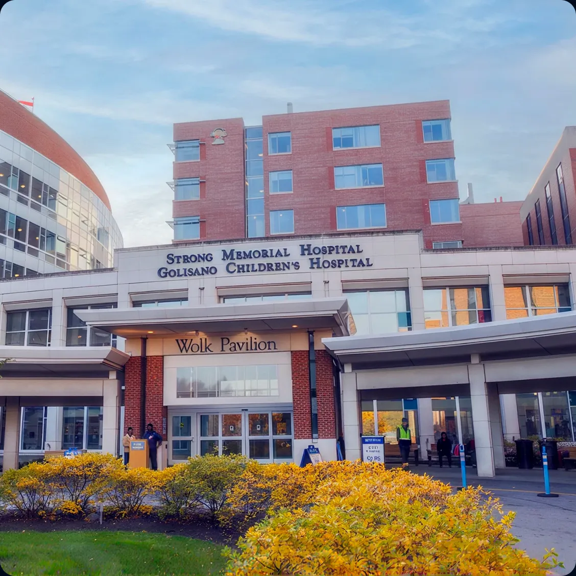 Entrance of Strong Memorial Hospital and Golisano Children's Hospital, with the Wolk Pavilion framed by golden shrubs.