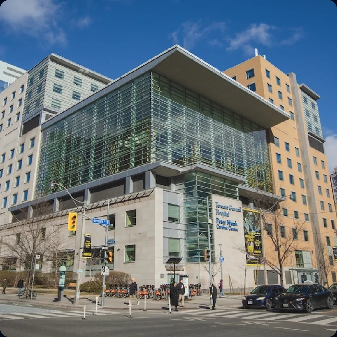 Street view of Toronto General Hospital's Peter Munk Cardiac Centre, a modern building with a glass facade.