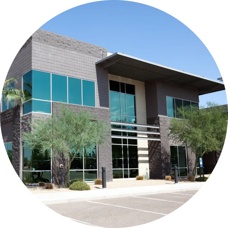 Imaging centre building with teal glass windows and desert landscaping