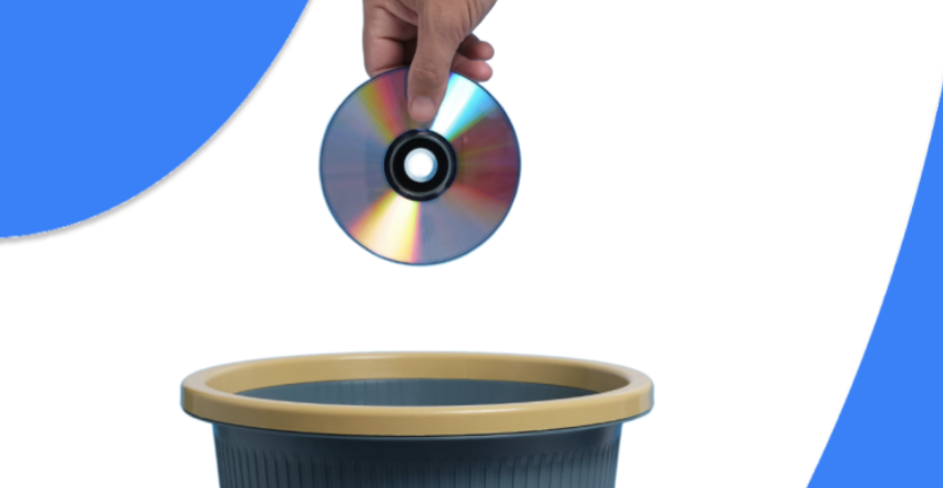 Hand dropping CD in a trash bin