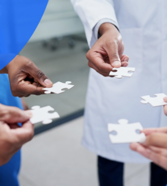 Health professionals reaching out with puzzle pieces