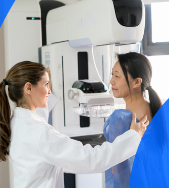 Radiologist guiding patient through her mammogram