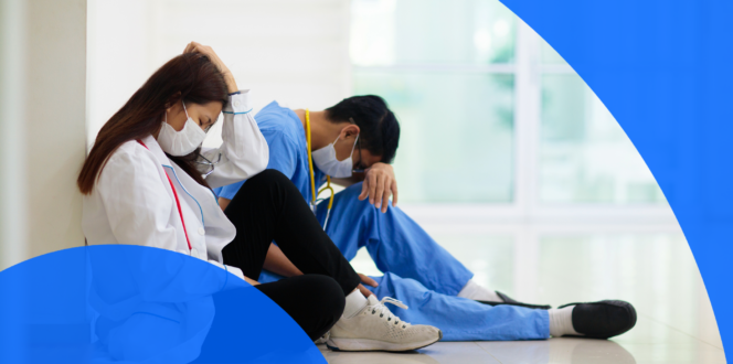 Two tired doctors resting in a hospital hallway