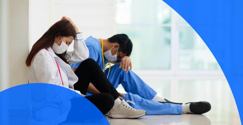 Two tired doctors resting in a hospital hallway