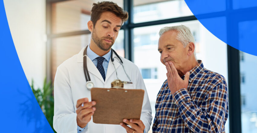 Doctor with clipboard reading charts to older man