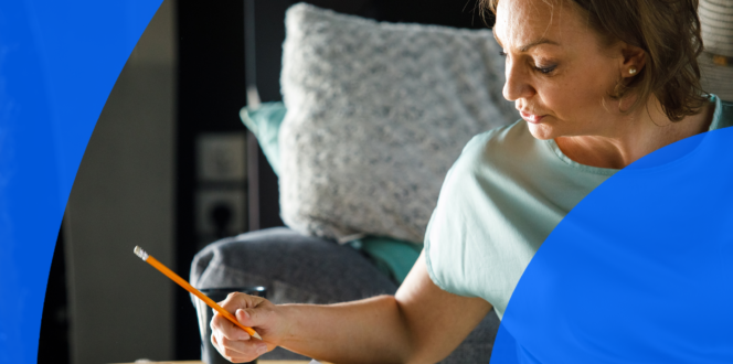 Woman holding a pencil and writing a to-do list