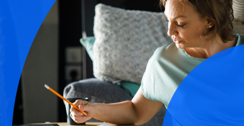 Woman holding a pencil and writing a to-do list