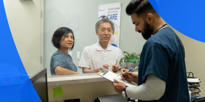 Nurse with two patients filling out forms at a hospital reception