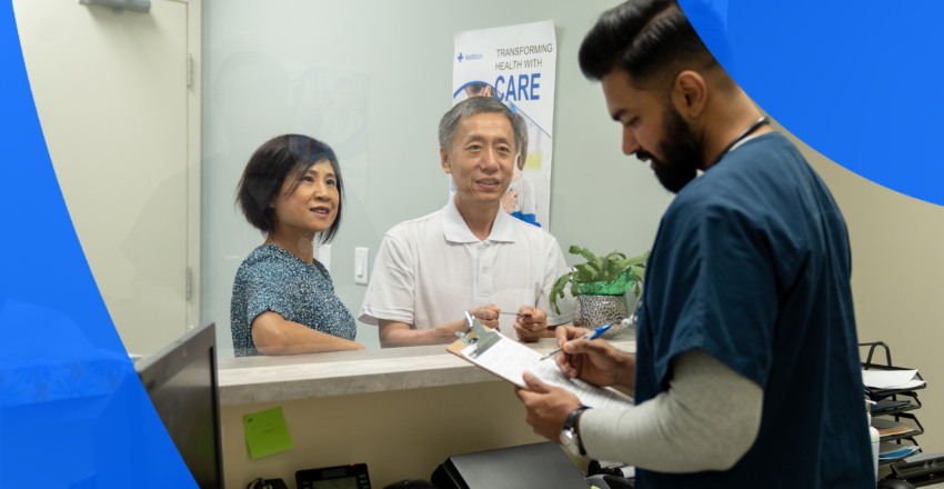 Nurse with two patients filling out forms at a hospital reception