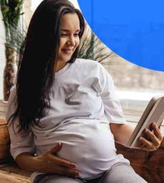 Pregnant woman reading imaging report on a tablet