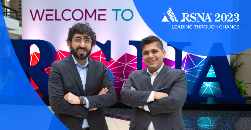 Rishi & Harsh Nayyar standing in front of the 2023 RSNA sign