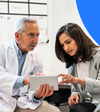2 healthcare providers reviewing enterprise image exchange solution on tablet