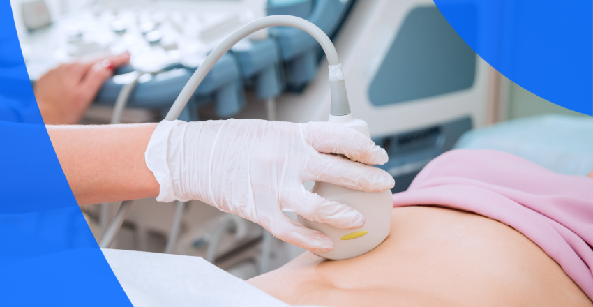An ultrasound technician performing an abdominal scan on a woman