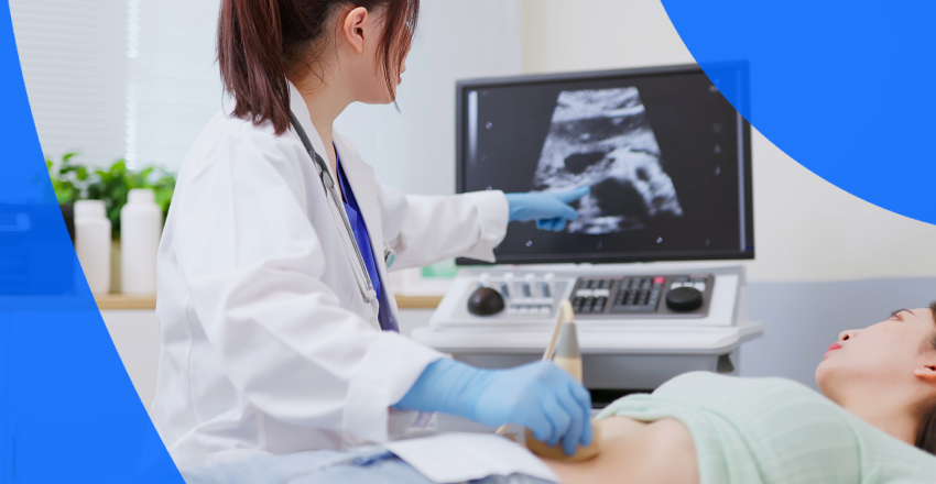 A technician performing an ultrasound on a patient