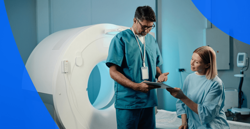 Patient and technician by a CT scan machine