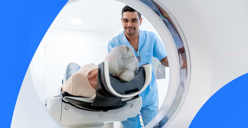 Patient getting a CT scan with smiling technician