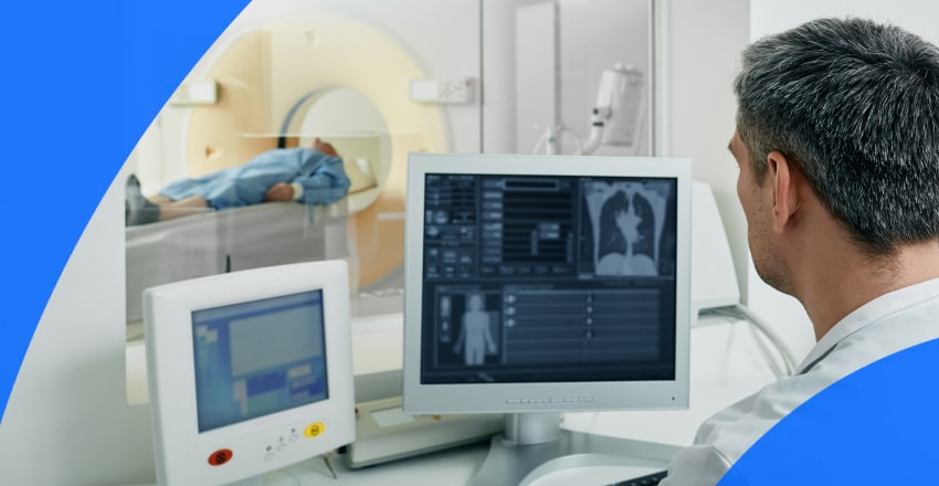 Patient and technician at a CT scan machine