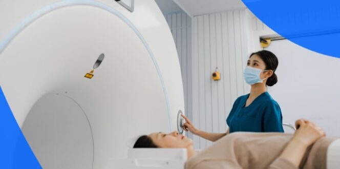 Patient and technician at a CT scan machine