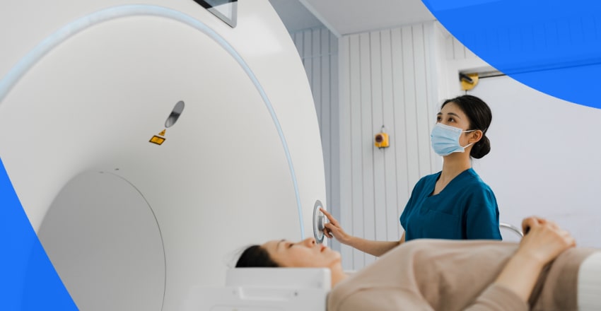 Patient and technician at a CT scan machine
