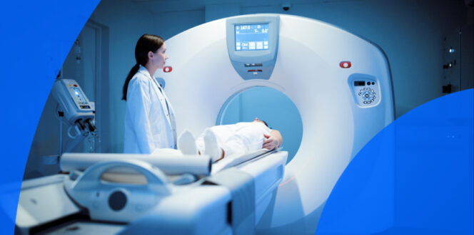 A radiologist stands beside a patient lying on the bed of a CT scanner used for bladder cancer management.