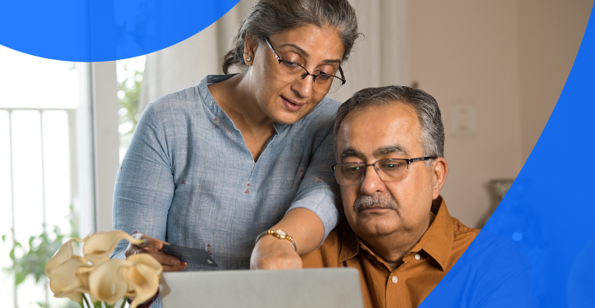 An elderly couple reviewing EMR vs EHR in Canada on their laptop.