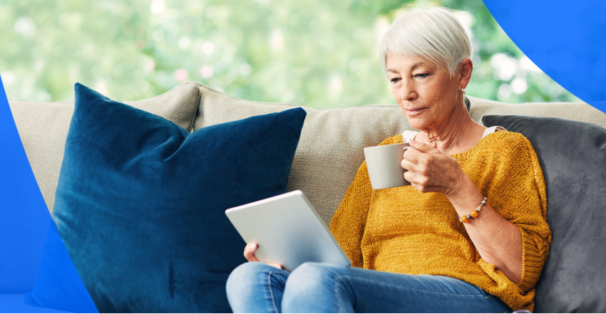 elderly woman sitting and reviewing her electronic health records on her tablet in Canada