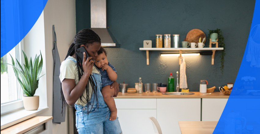 Mom with a toddler in her arms talking on the phone to learn how to view medical records online in Canada.