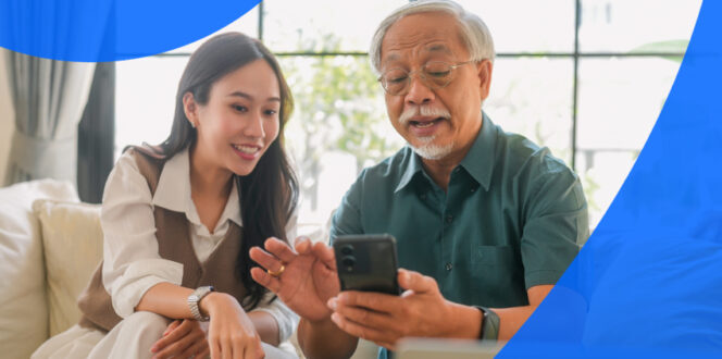 Elderly father and adult daughter looking at a phone together to learn how to view medical records online in Ontario.